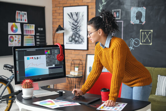 Young female designer working in office