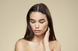 © SHOTPRIME STUDIO - Brunette with bare shoulders close-up long hair beige background clean skin