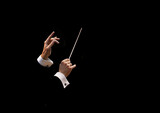 Fototapeta  - Conductor's hands on a black background
