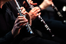 Hands Of A Musician Playing The Flute In An Orchestra 
