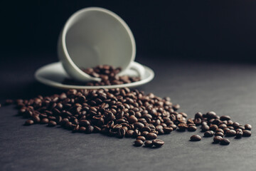 cup and saucer coffee beans morning breakfast close-up dark background