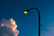 © Cagkan - Illuminated street light and pole against blue evening sky