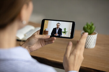 Canvas Print - Close up of businesswoman talk speak on video call on cellphone with male business partner. Woman have webcam online conference or digital virtual event on smartphone with boss or director.