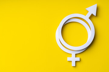 Gender equality symbol on yellow background, copy-space