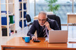 © Elnur - Old businessman employee working in the office
