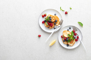 Wall Mural - Pancakes with fresh blueberry and raspberry.