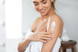 Woman Applying Moisturizing Lotion On Shoulders Caring For Skin Indoor