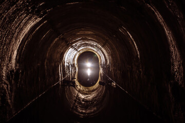 Poster - Flooded round sewer tunnel with water reflection