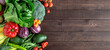 Fresh organic vegetables on a wooden table with copy space. Banner.