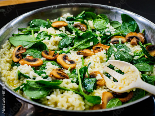 Risotto with champignons and spinach cooking in frying pan
 © Jacek Chabraszewski