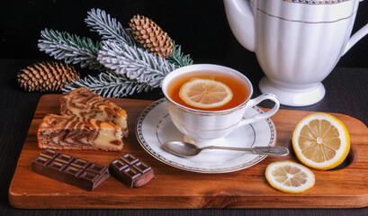 Wall Mural - tea with lemon, drying, chocolate and Christmas tree branch