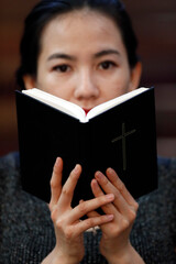 Poster - Catholic woman reading the bible in church.  Hue.  Vietnam.  25.02.2017