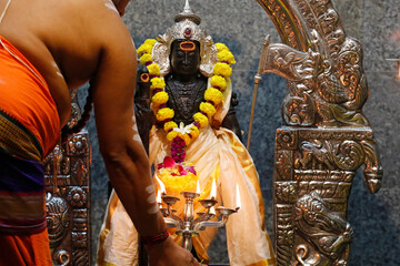 Wall Mural - Sri Mahamariamman Hindu Temple.  Murugan hindu god of war. Hindu priest performing puja ( religious offering ).  Kuala Lumpur. Malaysia.  11.12.2019