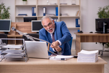 Wall Mural - Old businessman employee after accident working in the office