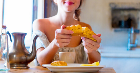 woman on true kitchen sitting on a table with bread