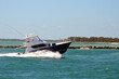 High-end sport fishing boat speeding through Government Cut in Miami,Florida.