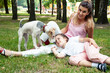 © iordani - young pretty caucasian mother walking with little cute daughter and dog fox terrier, lifestyle people concept