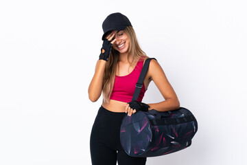 Wall Mural - Young sport woman with sport bag over isolated white background laughing