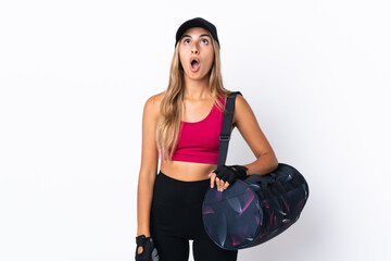 Wall Mural - Young sport woman with sport bag over isolated white background looking up and with surprised expression