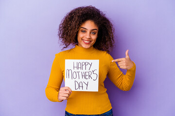 Wall Mural - Young African American woman holding a Happy motherâ€™s day placard isolated person pointing by hand to a shirt copy space, proud and confident