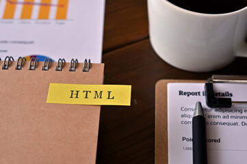 Poster - There's a cup of coffee, dummy documents and a notebook with a sticky note on it that says HTML written on it. It was an abbreviation for HyperText Markup Language.