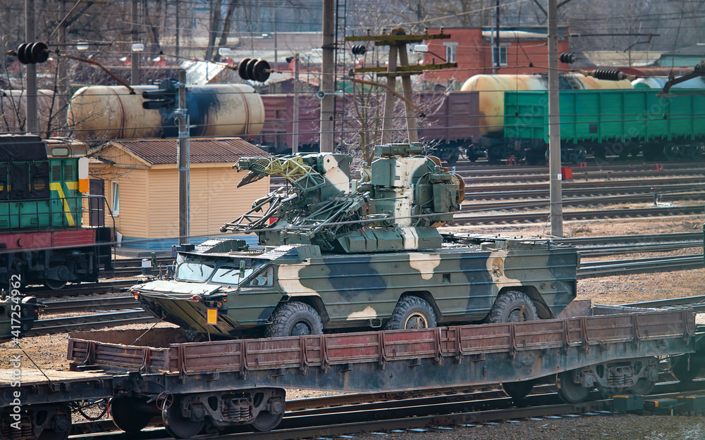 Train transporting military vehicles. Armored machine, military ...