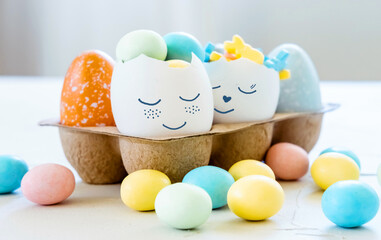 Cute Easter eggs with funny faces full of sweet candies. Easter and spring celebration concept