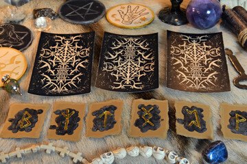 Sticker - Tarot cards and runes with magic ritual objects and crystals on witch table.