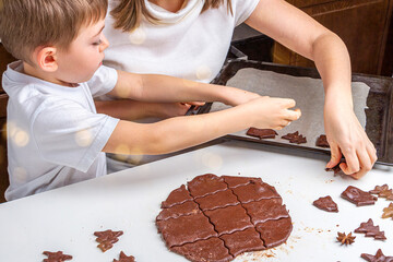 Cooking Christmas and  New Year chocolate cookies or gingerbread. Traditional festive baking, bake with kids. Step 12 spread dough figures on baking sheet. Step by step recipe  n