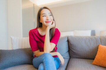 Wall Mural - Portrait beautiful young asian woman relax smile on sofa in living area