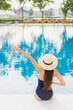 © siraphol - Portrait beautiful young asian woman relax smile around outdoor swimming pool in hotel resort