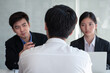 © kasinv - Business man and woman as employer interviewing male employee or job candidate applicant in office. Business career, employment, and placement concept.