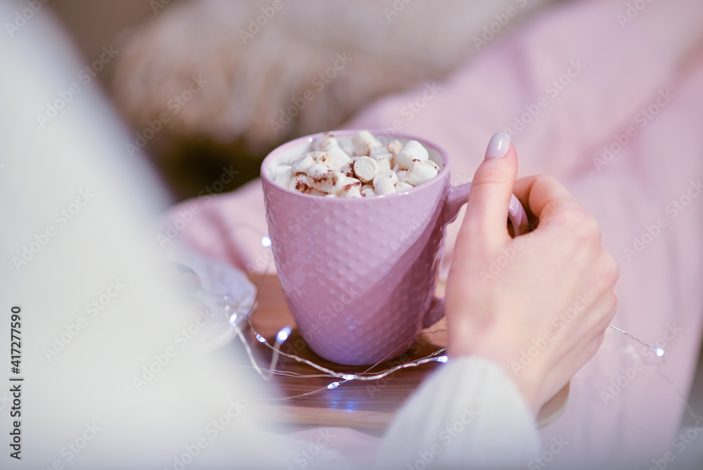 Beautiful young woman drinking hot chocolate at home, closeup