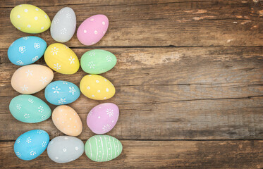 Painted Easter eggs lying on a wooden background