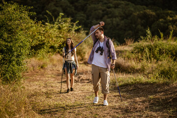 couple is hiking in mountain. they are tired.