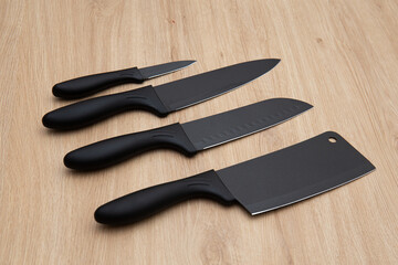 set of black luxury kitchen knife on wooden table 