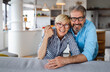 © NDABCREATIVITY - Cheerful senior couple enjoying life together, having fun at home