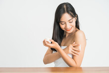 Young Skin Care Asian Woman Applying Body Lotion On Arm And Shoulder