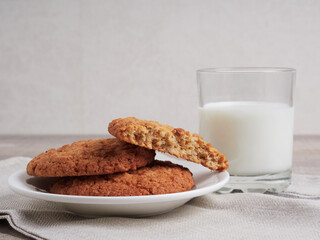 Homemade shortbread kamut cookies with glass of milk on light background