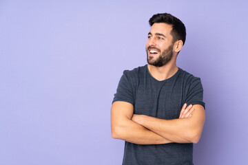 Sticker - Caucasian handsome man happy and smiling over isolated purple background