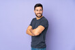 © luismolinero - Caucasian handsome man looking to the side and smiling over isolated purple background