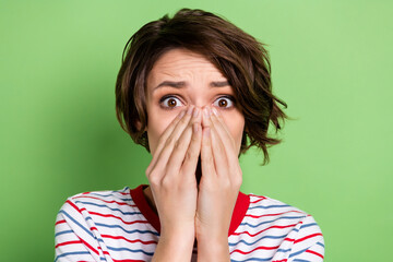 Poster - Close-up portrait of pretty worried girl got spooky news closing face omg isolated over green pastel color background