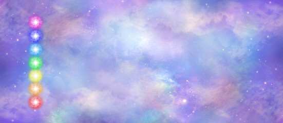 Wall Mural - Celestial Sky Chakra Vortex message banner - a neat stack of seven rainbow coloured chakra vortexes on left side  against a beautiful heavenly sky background with copy space
