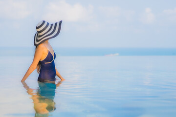 Portrait beautiful young asian woman relax around swimming pool in hotel resort