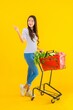 © siraphol - Portrait beautiful young asian woman shopping grocery from supermarket and cart