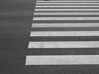 white line of crosswalk on the asphalt road