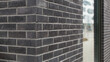 Gray brick wall with window. Brick wall corner. 
Graue Backsteinmauer mit Fenster. 
Ecke einer Ziegelmauer.