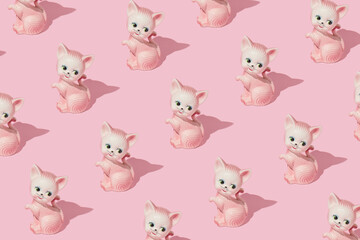 Wall Mural - Creative pattern made with cat or kitten vintage figurine on pastel pink background. Retro aesthetic idea. Romantic vintage concept.