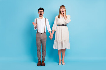 Sticker - Photo of sweet impressed couple wear white outfit holding arms together hand cheek cheekbone isolated blue color background