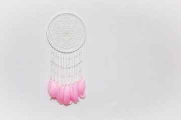 Wall Mural - Handmade dream catcher with feathers threads and beads rope hanging on white background